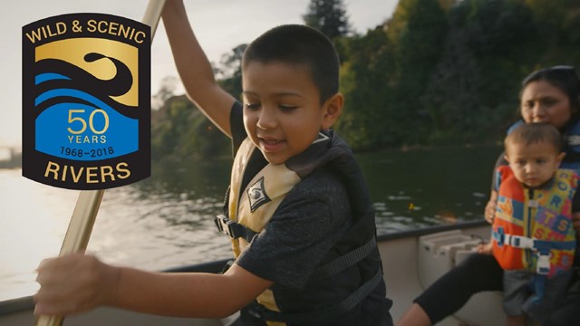 Child paddling on a river